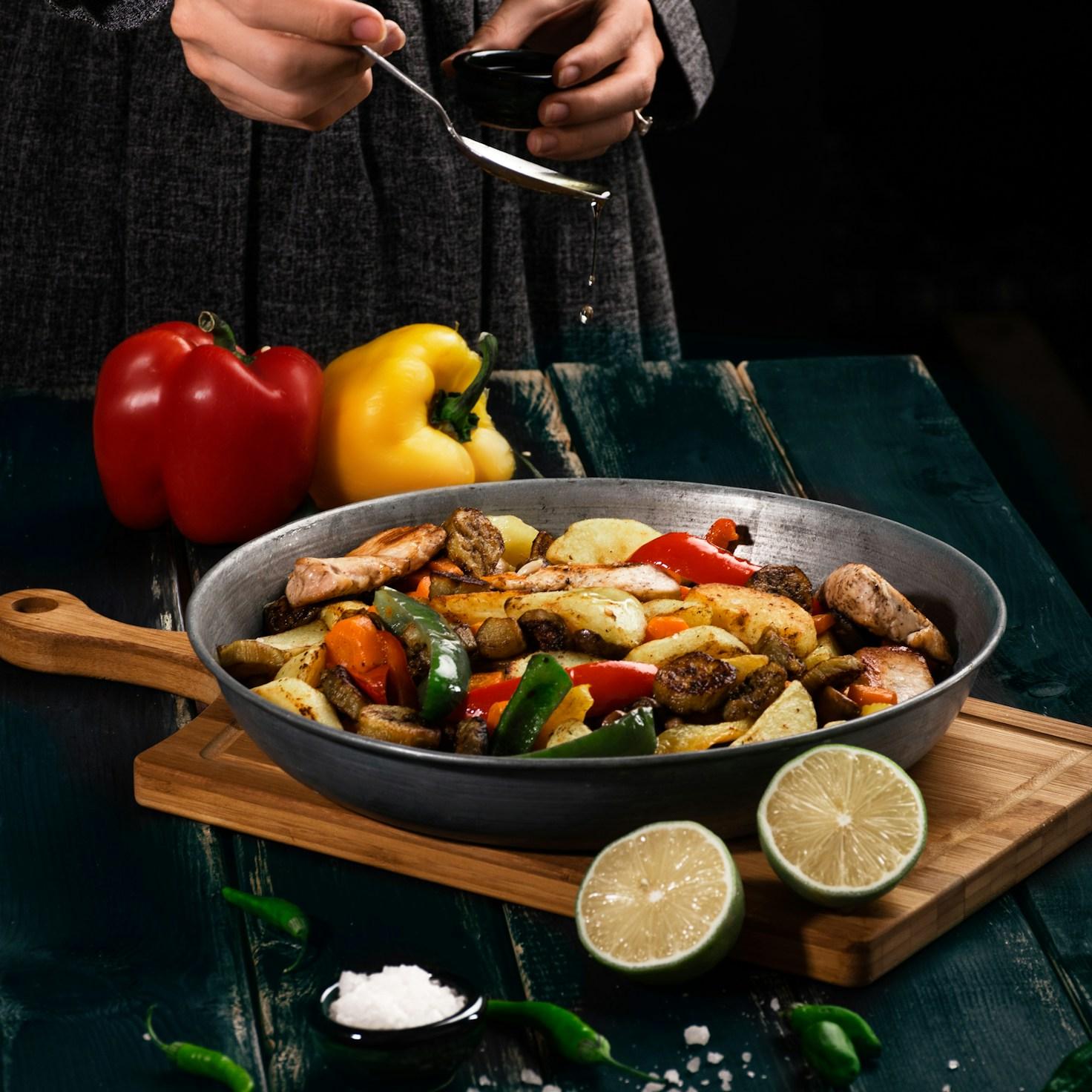 Diverse group of community members sharing a meal together, showcasing the social bonds formed through collaborative cooking